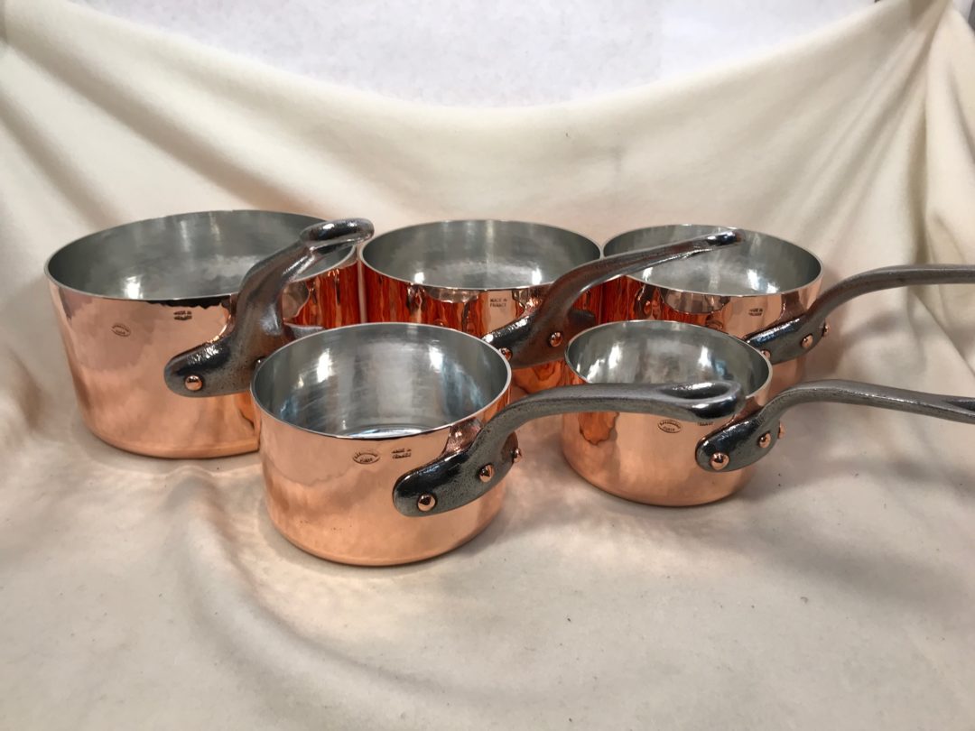 Set of 5 hammered French copper tin lined sauce pans marked Dehillerin